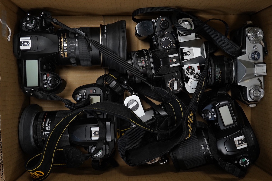 Eight SLR and DSLR camera bodies by Nikon, Zenit-E, Fujifilm, Canon, etc., together with thirteen lenses, a boxed Rollei A110 and other accessories including camera cases, etc. Condition - poor to fair.